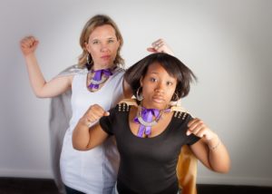 Big Sister Kara and Little Sister Ainayasha flex their muscles and pose with capes on for the Hero Campaign. 